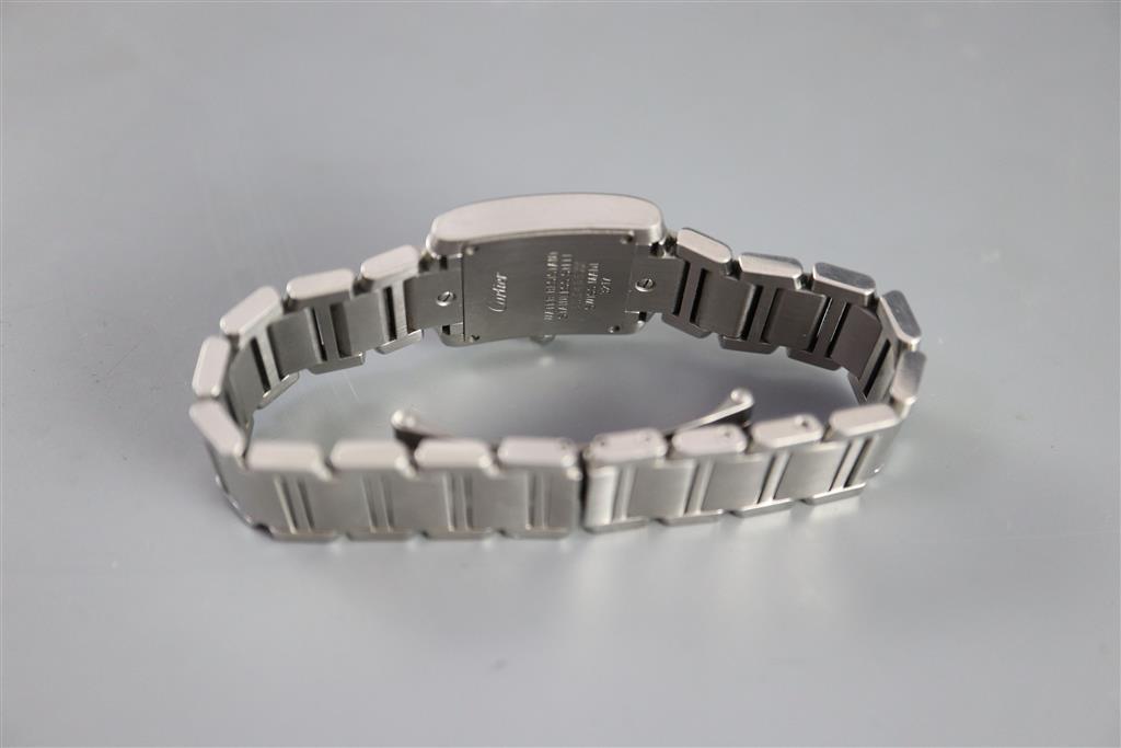 A ladys modern stainless steel Cartier Tank quartz wrist watch with diamond set numerals,